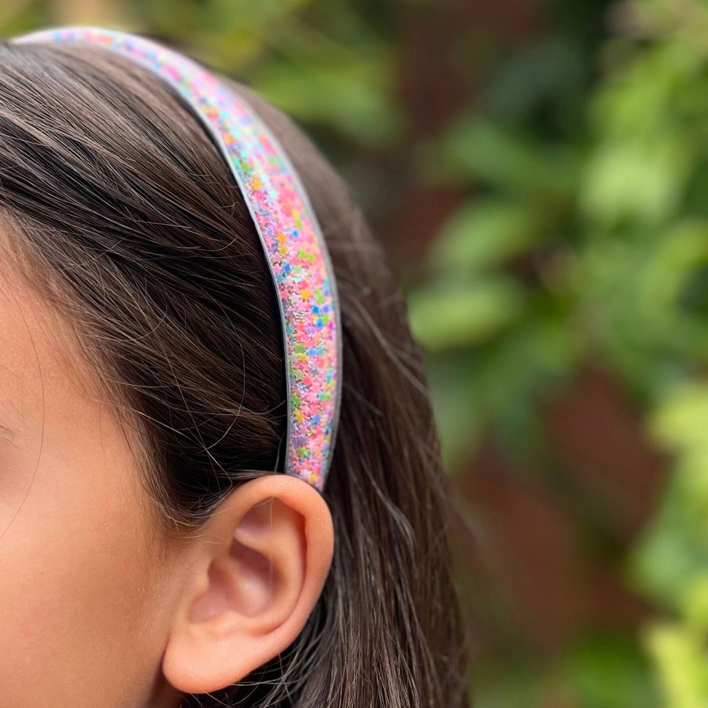 Kids headband with swirling confetti, perfect for adding a fun, colorful touch to any hairstyle for parties or everyday wear.