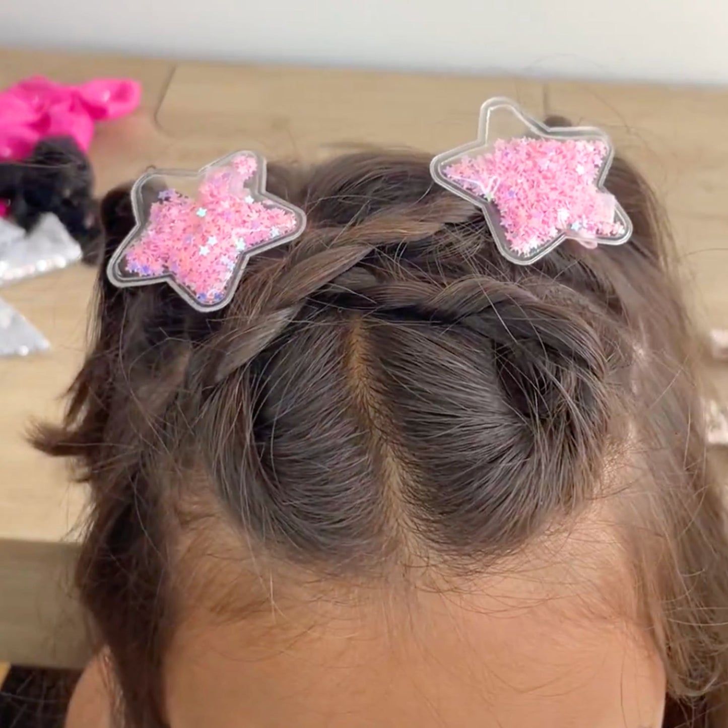 Confetti star hair clips, featuring sparkling designs that provide a secure hold and a playful flair.
