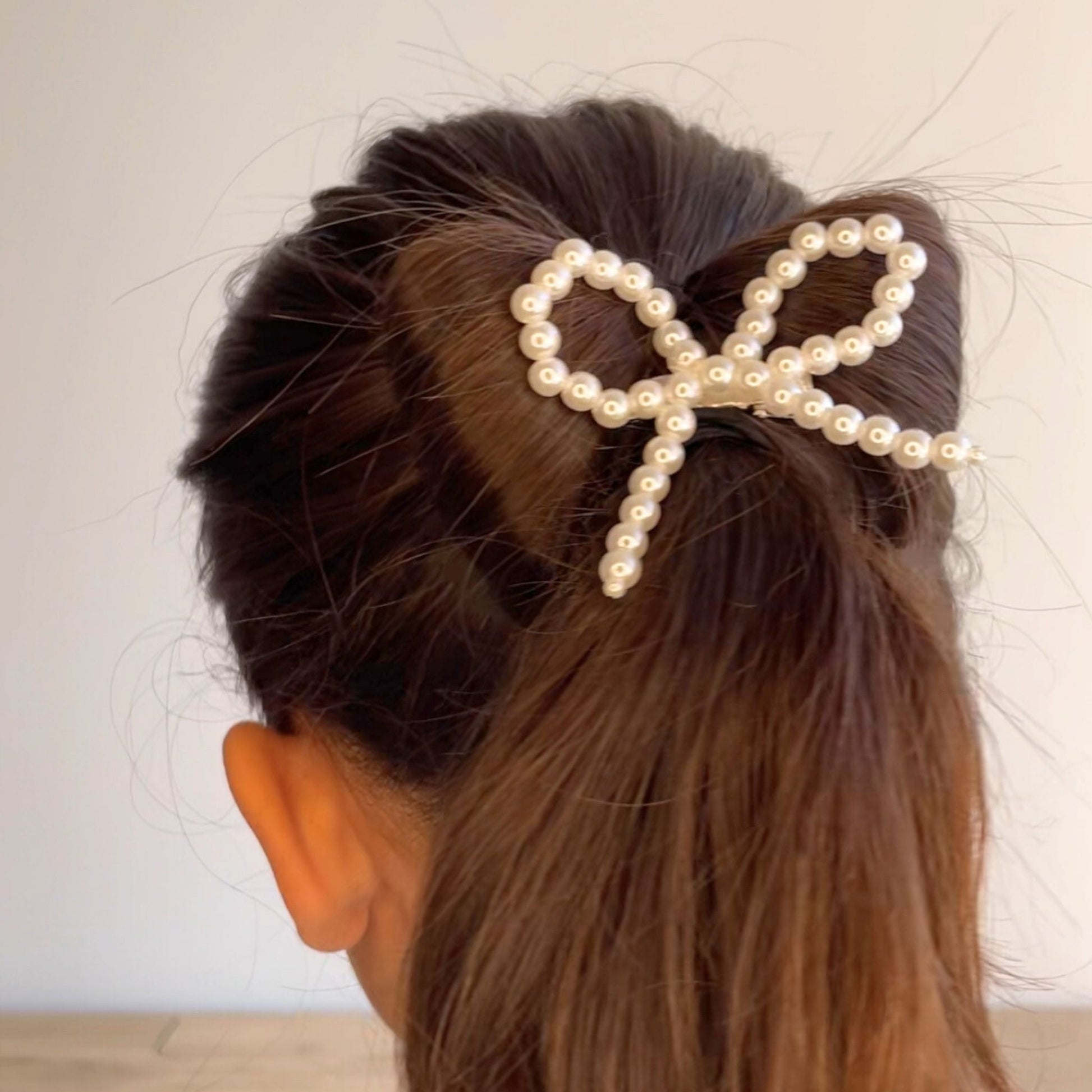 Pretty pearl hair bow clip for kids, perfect for dressing up hairstyles for any event or casual outing.
