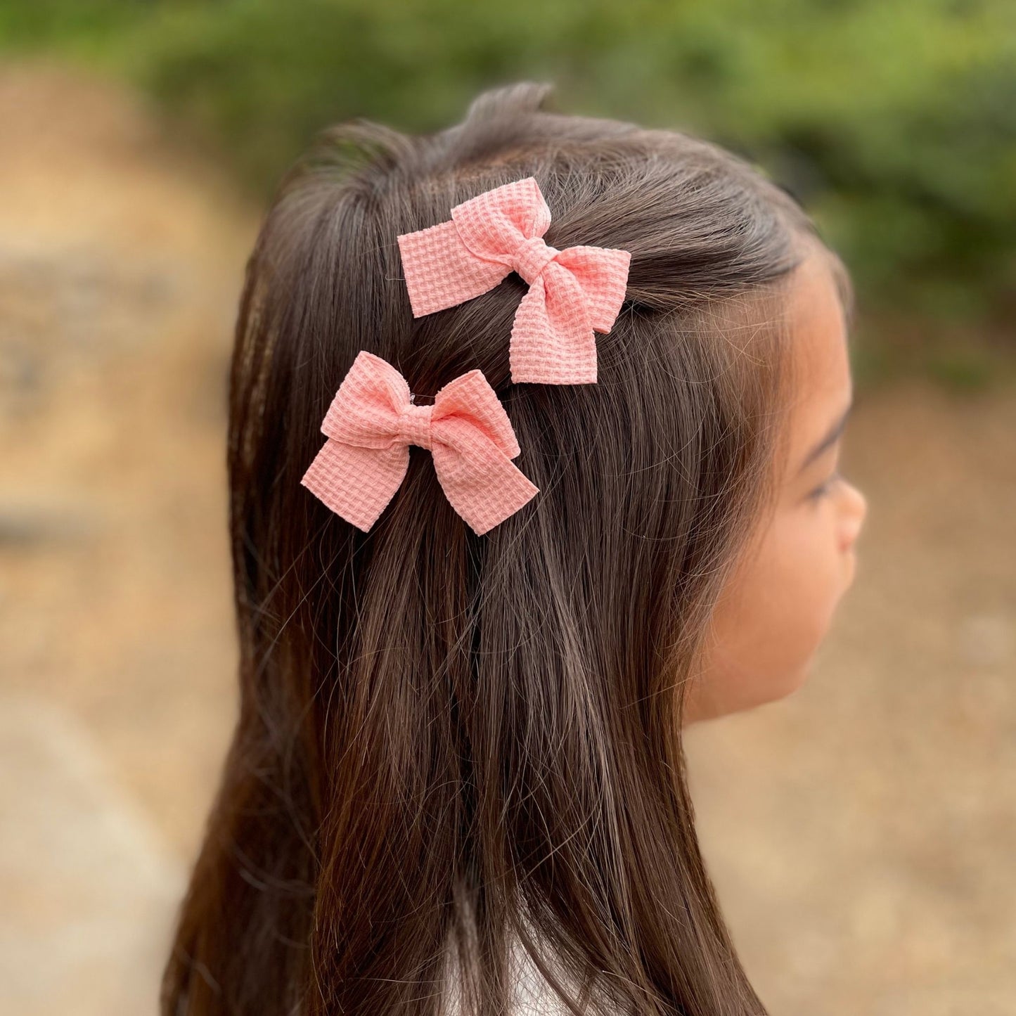 Soft waffle knit hair bow clips for girls, designed with a textured look to add a cozy, stylish touch to their hairstyles.