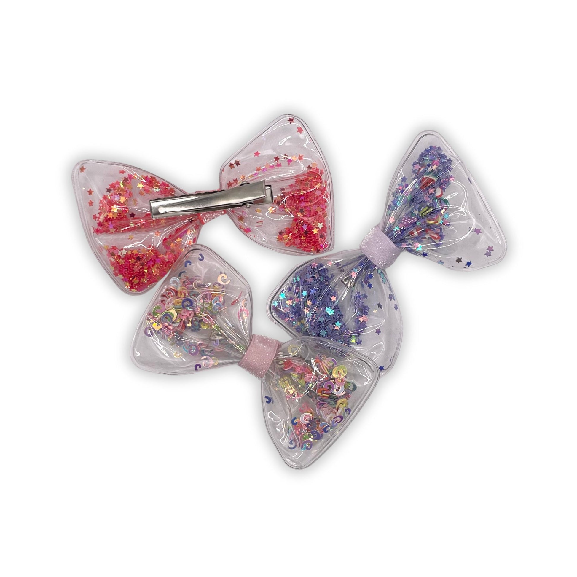 Festive confetti-filled bow clip that adds playful charm and color to kids hairstyles.