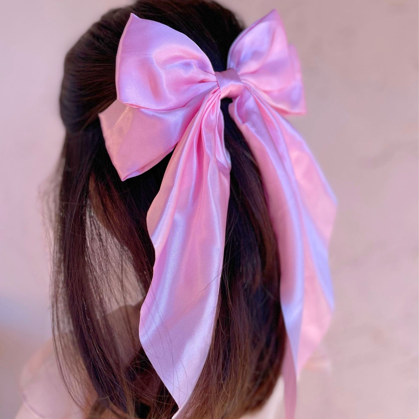 Stylish satin hair bow for kids, featuring a smooth texture, perfect for complementing formal or everyday outfits.