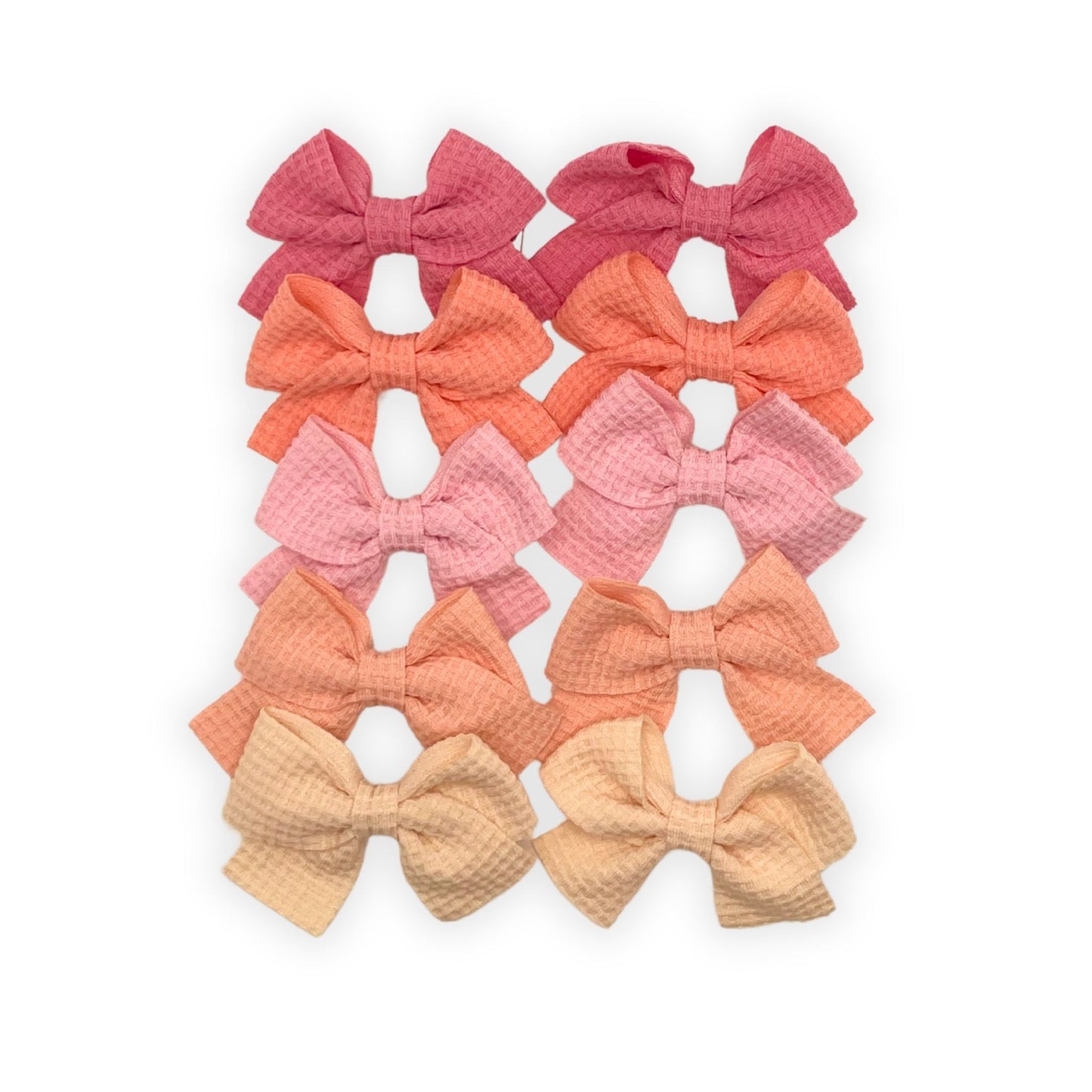 Kids waffle knit hair bow clips in soft, textured fabric. Stylish and perfect for everyday hairstyles or special occasions.