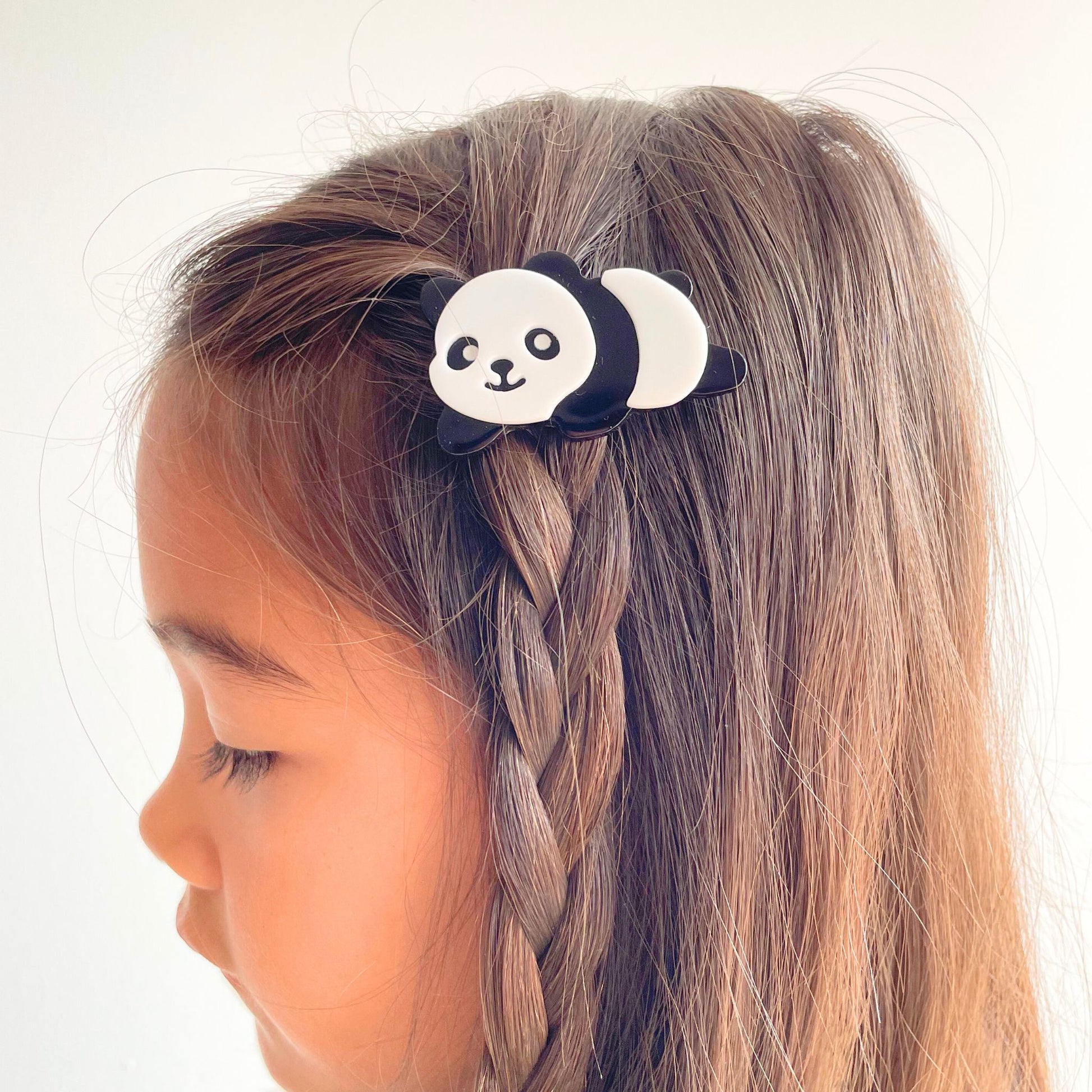 Cute panda hair accessory designed to securely hold hair while adding charm to any outfit.