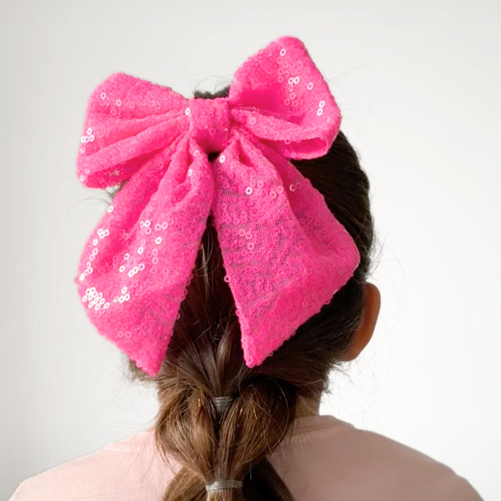 Sparkly kids sequin hair bow, perfect for adding a dazzling touch to any hairstyle for parties or special events.