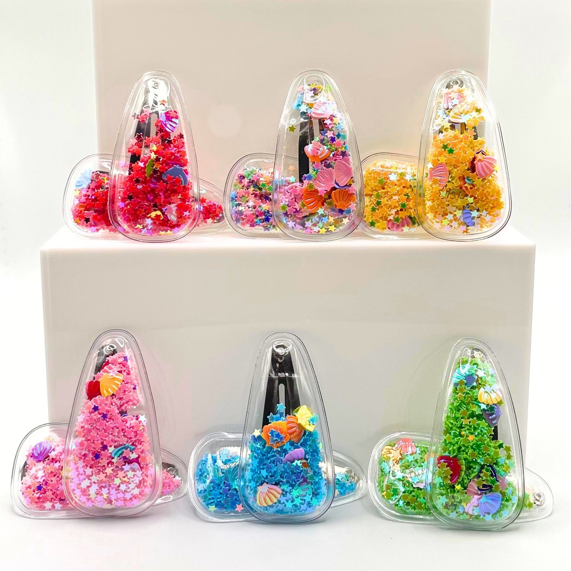 Colorful kids seashell-filled confetti hair clips that shake with every move, perfect for fun, unique hairstyles.