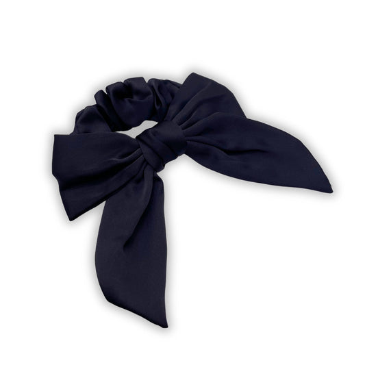 Satin hair bow scrunchie, offering a soft, luxurious hold for ponytails while adding a stylish bow detail.